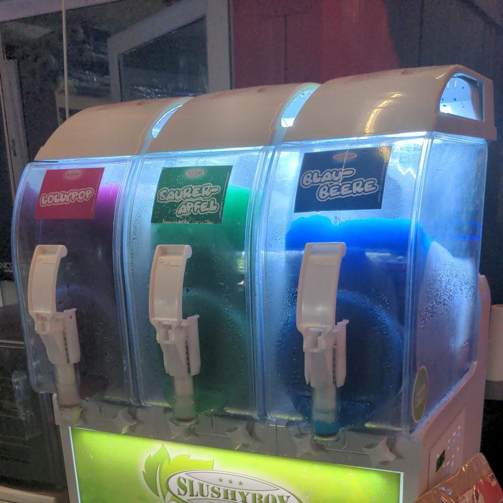 Three slushie machines with flavors: lollipop, sour apple, blue berry.